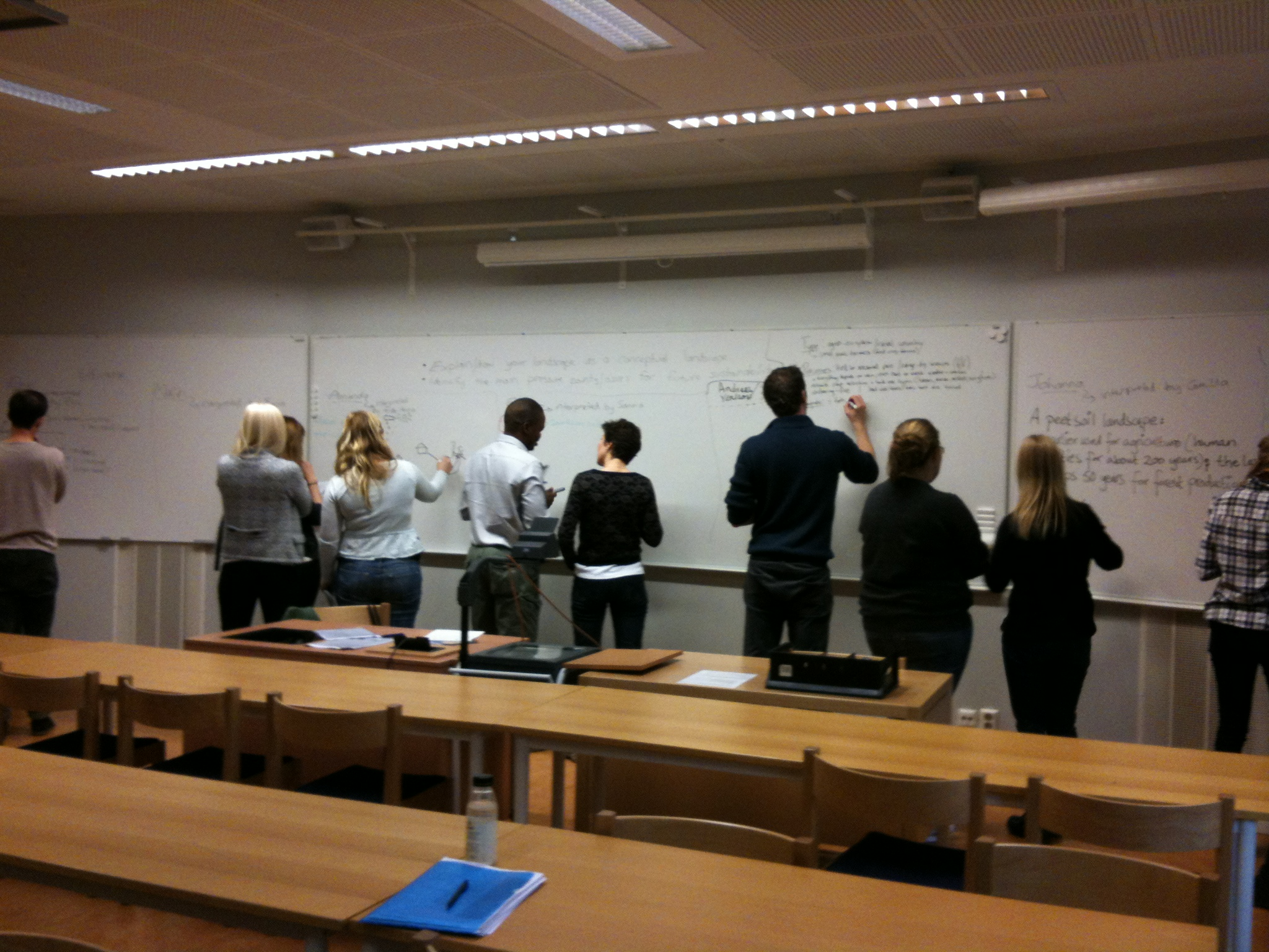 students writing on whiteboard